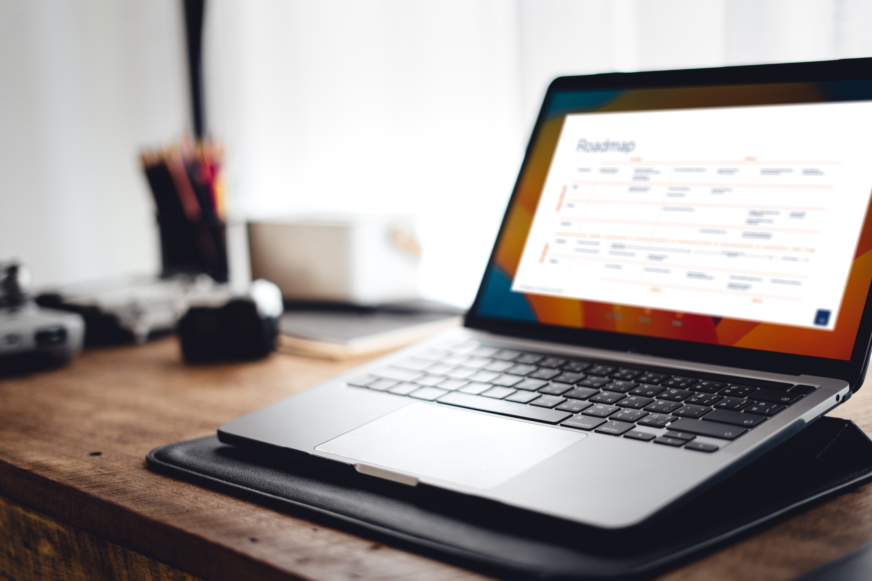 Laptop on a desk, with a digital strategy roadmap